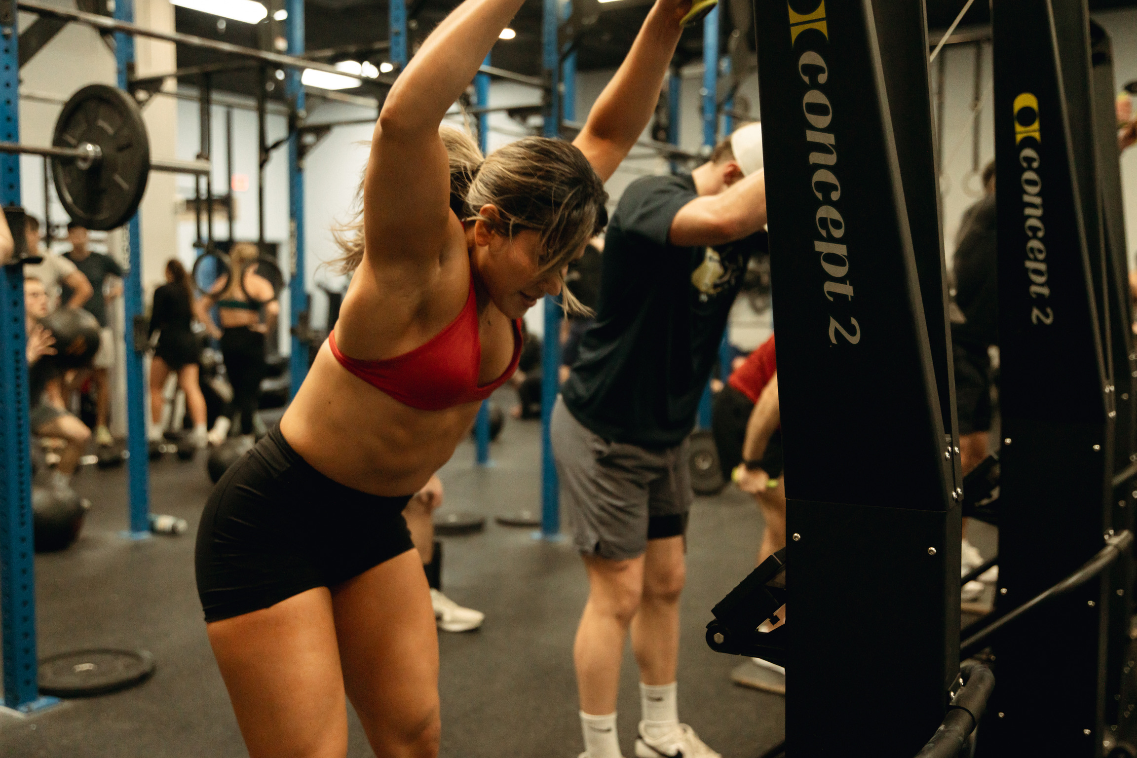 Athlete mid-workout in a packed class