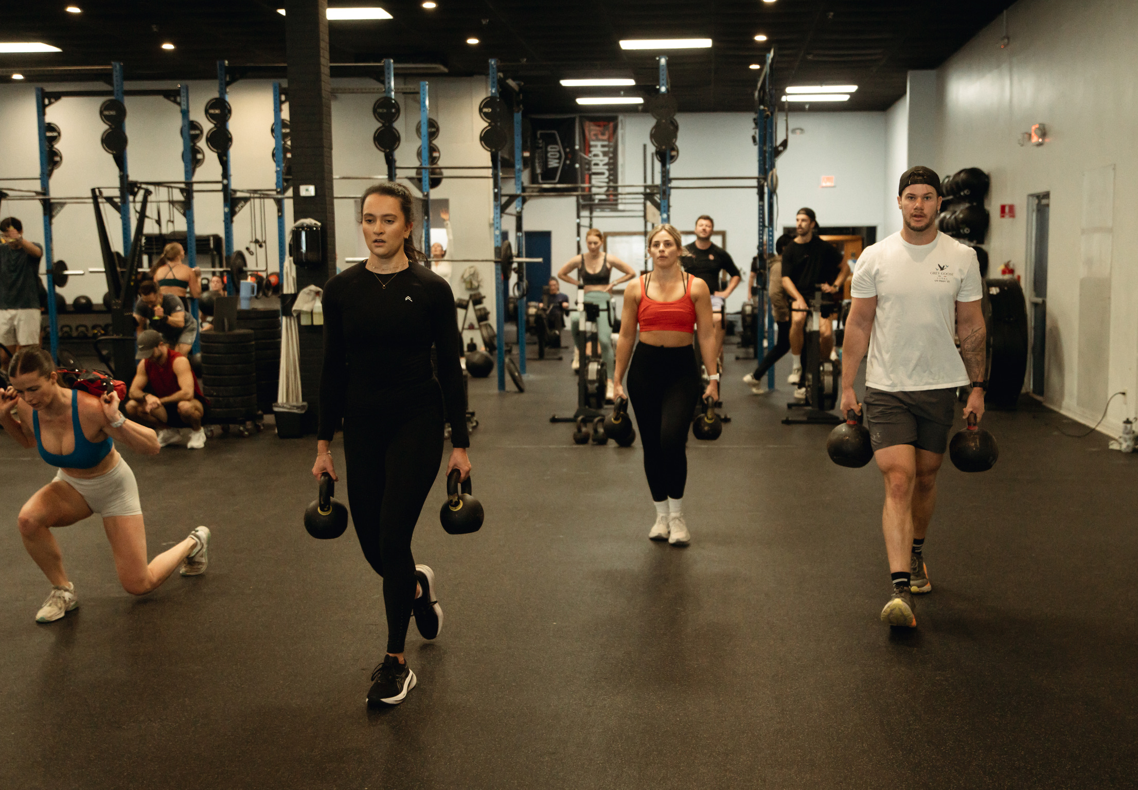 Class working through a kettlebell carry